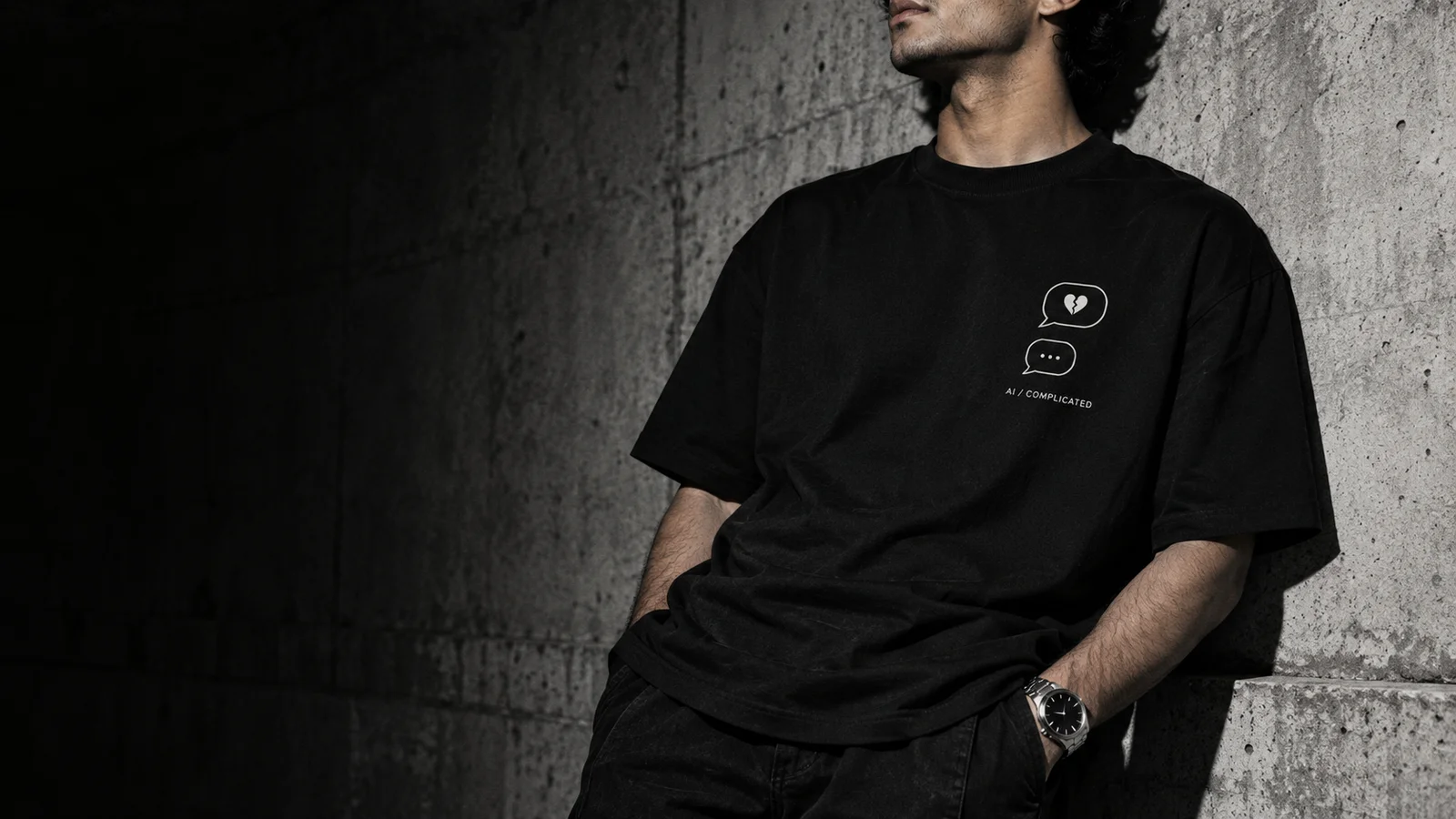 Original campaign concept: black graphic tee and steel watch